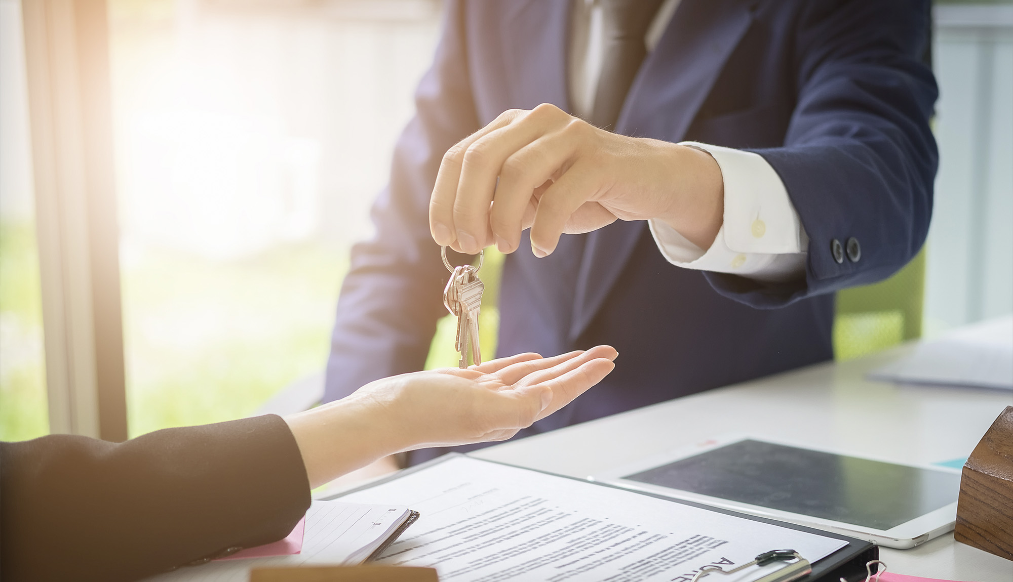 two individuals doing a real estate transaction